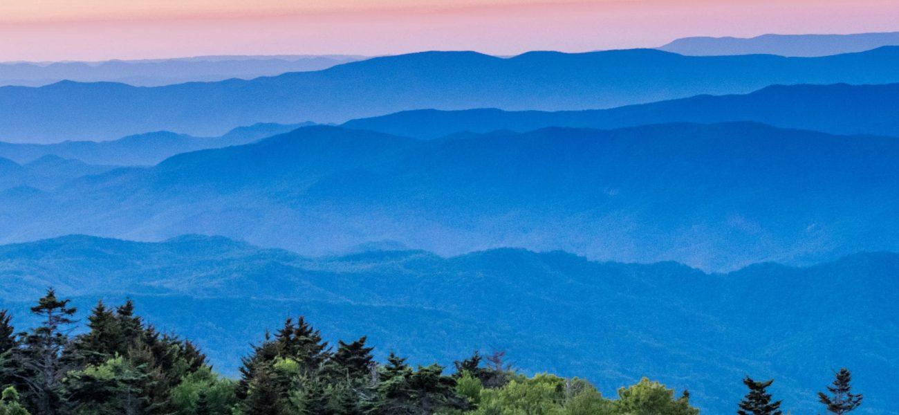 Hazy Blue Ridge Mountains at Sunset with grass bald in foreground